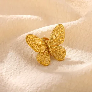 Exquisite golden butterfly brooch detail view, delicate textured metal craftsmanship.