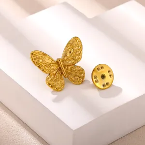 Detailed view of exquisite gold butterfly lapel pin accessory showcasing fine wing texture.