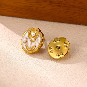 Close-up detail of the elegant 18k gold plated stainless steel enamel flower brooch with pearl.