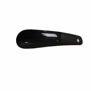 Portable black plastic shoehorn with hanging hole, lightweight and durable for daily use.