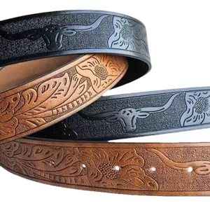 Close-up of western style embossed leather belt, detailed bull head and floral carved texture strap.
