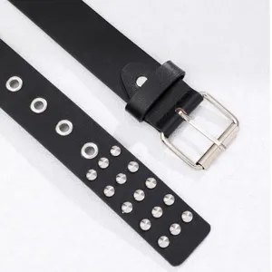 Black punk leather belt detail showing metal buckle, eyelets, and double-row rivet studs.