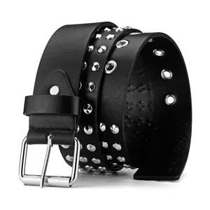 Black punk leather belt with metal grommets and rivets, detailed view of retro style trouser accessory.
