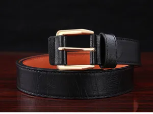 Close-up detail of the classic black leather belt with gold pin buckle and brown lining.