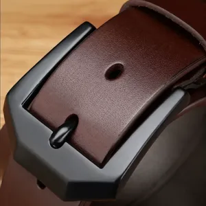 Close-up detail of men's brown leather belt with black metal buckle, business style.