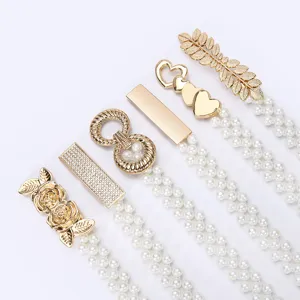 Detail view of women pearl rhinestone elastic waist belt set for dress sweater decorative.