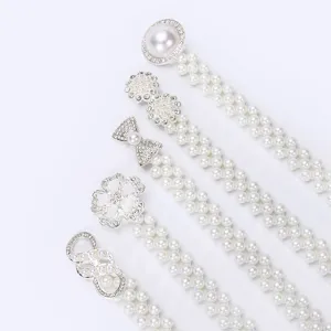 Detail shot of stylish women pearl rhinestone decorative waist belt set with multiple buckle styles.