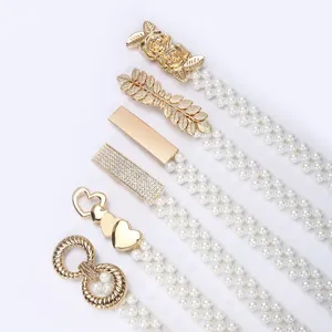 Detailed view of women's fashion pearl waist chain set with various gold metal buckles for dresses.