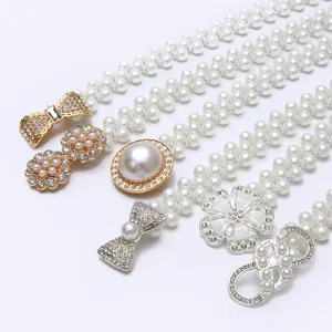 Elegant women's pearl waist belt featuring sparkling rhinestone bow and flower buckles for dresses.