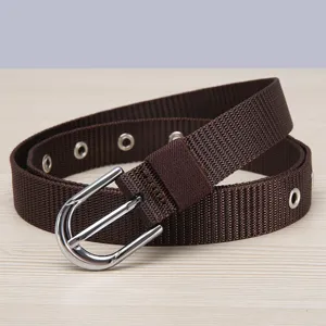 Brown nylon canvas belt detail view, showcasing woven texture and metal buckle.