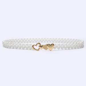 Pearl belt dress sweater waist chain with gold heart buckle, elegant women accessory detail.