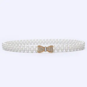 Pearl rhinestone belt detail showcasing dual-row pearls and sparkling bow clasp design.