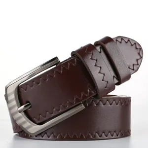 Close-up detail of dark brown mens casual PU leather belt with metal buckle and stitching.
