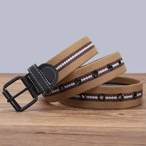 Detail shot of the canvas belt showing the metal buckle texture and full metal eyelets.