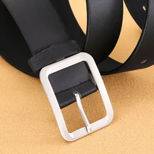 Close-up detail of black PU leather belt with silver rectangular pin buckle, casual.