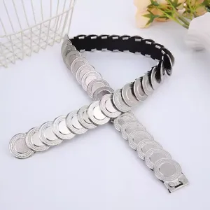 Silver coin metal stretch waist belt detail showing interlocking fishscale disc links.