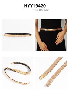 Detail view of women's gold metal coin stretch belt with elastic band for dresses.