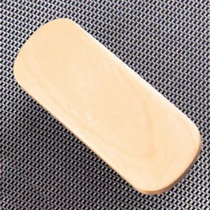 Wooden handle detail of a cleaning brush, showing smooth polished natural wood surface texture.