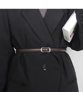 Close-up detail view of women thin waist belt in dark brown PU leather with elegant metal buckle.
