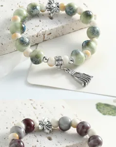 Detail view of Jingdezhen ceramic beaded bracelet, new Chinese style with metal charms and tassel.