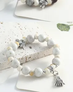 Close-up detail of Chinese style Jingdezhen ceramic beaded bracelet with metal charms.