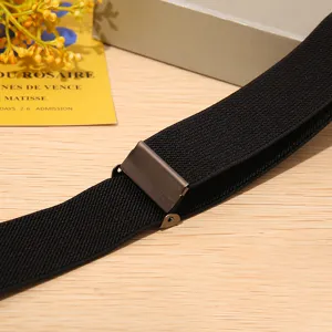 Detailed view of women's buckle-free elastic stretch belt with metal adjuster on wood.
