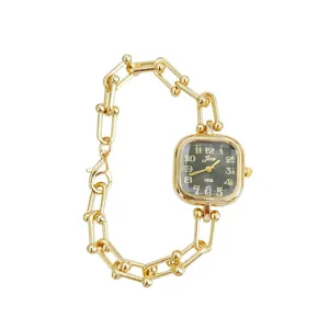 Elegant gold-toned women watch featuring a unique square dial and bold link chain bracelet.