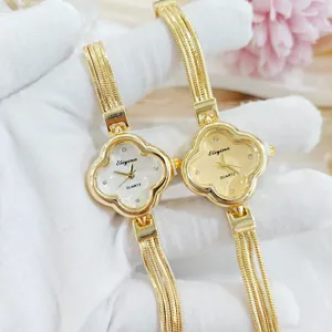 Orologio da donna al quarzo trifoglio elegante bracciale dorato con quadrante luminoso.