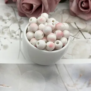 Ceramic DIY loose beads detail view, pink splash glaze round porcelain beads for handmade jewelry.