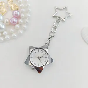 Star keychain watch detail, metal five-pointed star pocket watch pendant and clear dial.