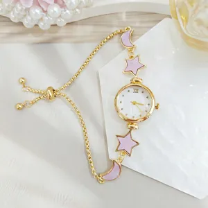 Delicate star and moon design ladies chain watch with purple enamel details and gold strap.