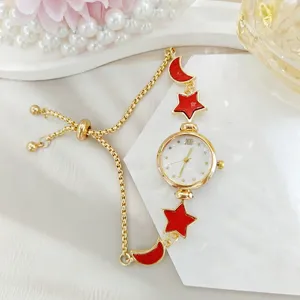 Women's quartz watch featuring a stylish gold-tone pull bracelet with red star and moon charms.