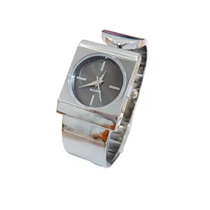 Square quartz watch detail, wide metallic bracelet band, minimalist women fashion accessory.