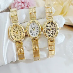 Montre quartz femme de luxe avec cadran ovale élégant serti de strass et chiffres romains.