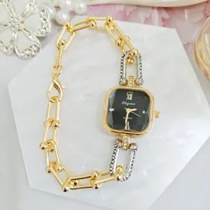 Elegant women's quartz watch with black square dial and chic gold chain strap design.