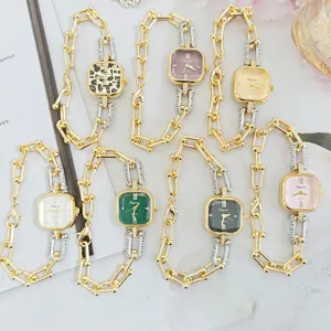 Detailed close-up view of luxury square chain wristwatches for women with multi-color dials.