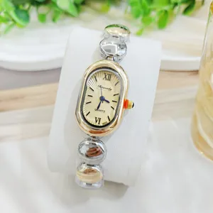 Elegante ovale Damenuhr mit Quarzwerk, goldenem Zifferblatt und stilvollem Kugelarmband für Damen.