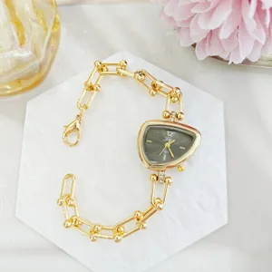 Detailweergave van een trendy onregelmatige dameshorloge met driehoekige wijzerplaat en armband.