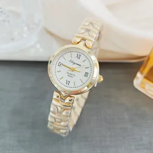 Gold-tone stainless steel strap women quartz watch with white Roman numeral dial detail.