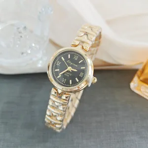 Elegant women quartz watch with gold steel strap, black dial and classic roman numerals.