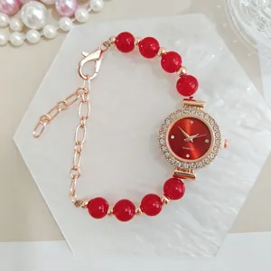 Elegant red beaded quartz watch bracelet for women with rhinestone dial and rose gold finish.