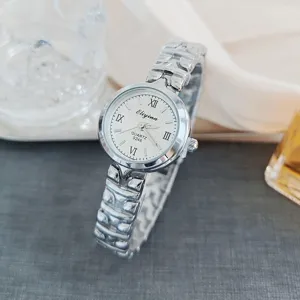 Close-up of women's quartz watch with Roman numerals and silver metal strap detail.
