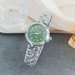 Green dial women quartz watch with roman numerals and stainless steel strap detail view.