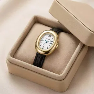 Elegante orologio donna al quarzo con cassa ovale dorata, cinturino in pelle e numeri romani.