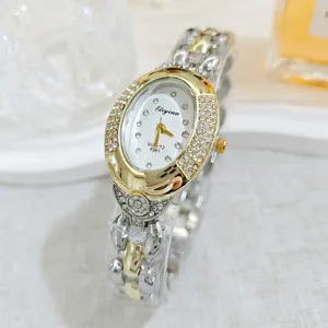 Luxury oval rhinestone quartz women watch with gold silver chain bracelet for elegant daily wear.