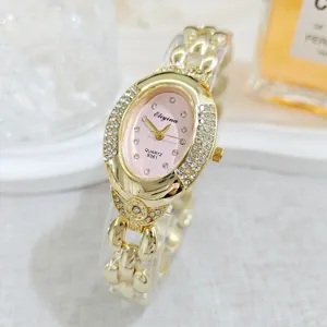 Vintage oval rhinestone quartz watch with gold chain bracelet, elegant luxury women timepiece.