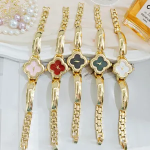 Detailed close-up of luxury four-leaf clover women watches set with metal chain straps.