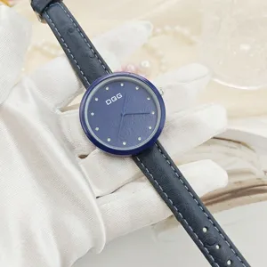 Women quartz watch with blue leather strap, rhinestone markers and elegant floral dial.