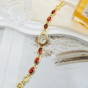 Vintage gold women quartz watch with red gemstone bracelet, retro luxury temperament wristwatch.