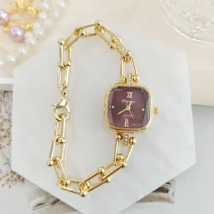 Detailaufnahme einer eleganten quadratischen Quarzuhr mit Goldgliedarmband und lila Zifferblatt.